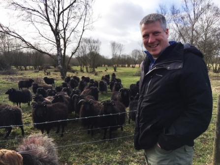 Picture of Paul Wilkinson standing near some sheep