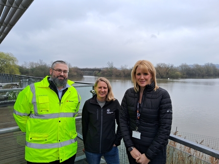 three people standing on a balcony over water at Attenborough Nature Reserve