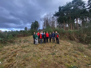 people standing in forest smiling