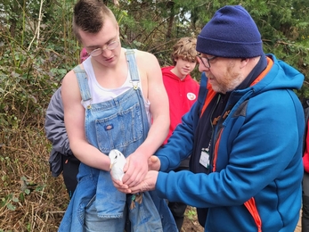 man helping someone hold a gull