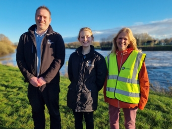 Three members of the project team stood in front of the River Trent