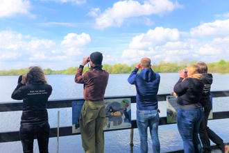Capital One Staff take in the birdlife at Attenborough Nature Reserve from the new pond dipping platform