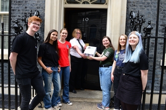 Handing the letter and petition into Number 10 downing street