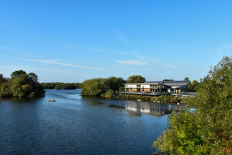 A view of Attenborough Nature Centre and Coneries Pond