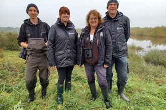 Four members of Nottinghamshire Wildlife Trust staff standing in field