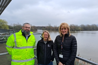 three people standing on a balcony over water at Attenborough Nature Reserve