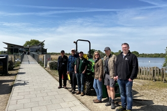 Tractor with a group of people in front
