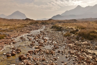 Rocky, rugged landscape with hazy mountains in the background