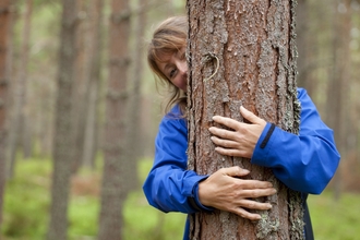 Woman hugging a tree