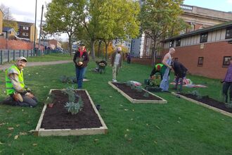 people making planters and planting 
