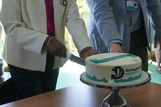Woman and man cutting a cake