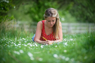 woman sketching on grass