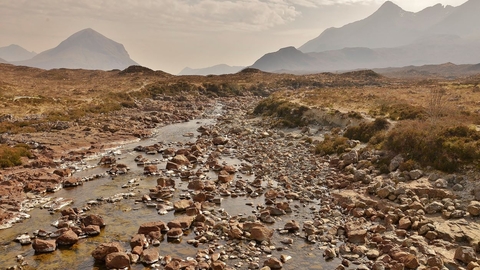Rocky, rugged landscape with hazy mountains in the background