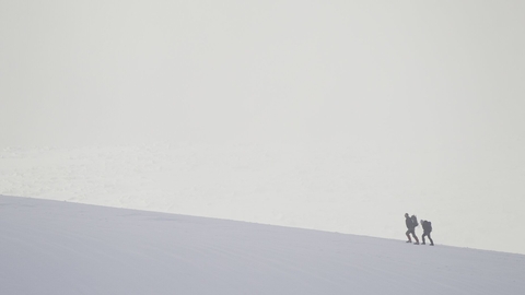 Lone hiker in winter, Cairngorm Mountains, Scotland.