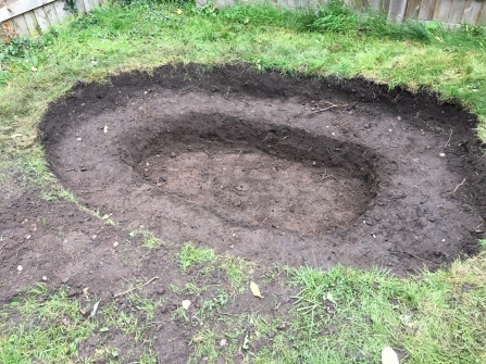Image of a garden pond in progress, no water or lining installed