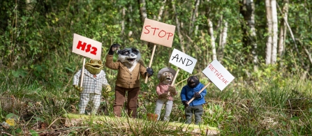 The Wind in the Willows characters carrying campaign placards reading HS2 Stop and Rethink