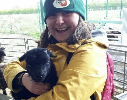 Mia Cross holding lamb