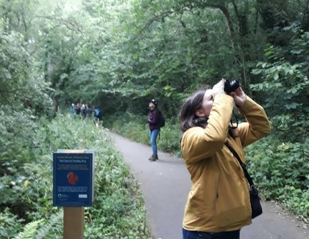 Mia Cross looking through binoculars