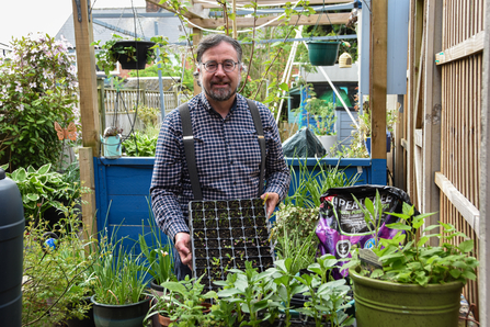 Erin McDaid smiling holding seedlings 