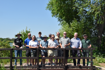 Beeston Wildlife Group stand on a bridge in Attenborough Nature Centre garden