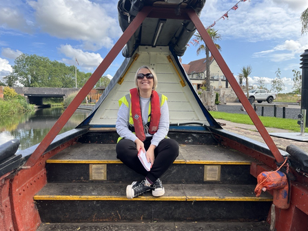 A woman smiling on a canal boat 