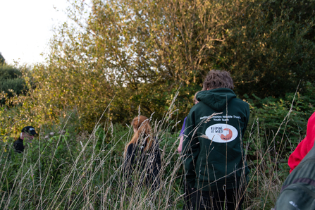 children going into long grass 