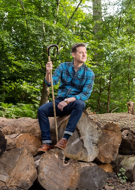 matt baker sat on rocks in woodland