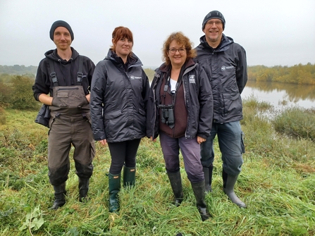 Four members of Nottinghamshire Wildlife Trust staff standing in field