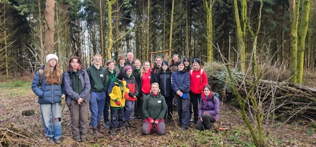 group of young people smiling in a forest