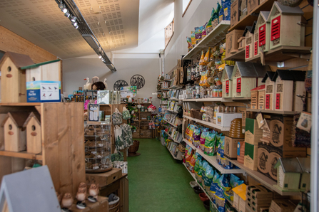 a shop with bird houses on the shelves 