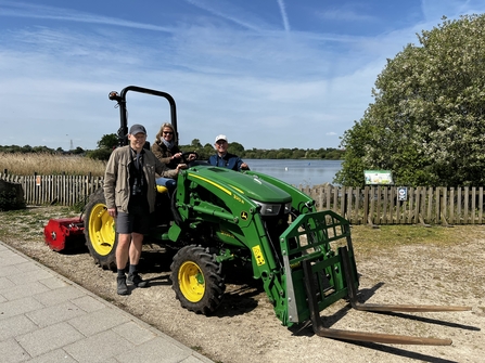 Tractor on land adjacent to water