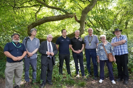 People gathered and lined up for photo in the woods