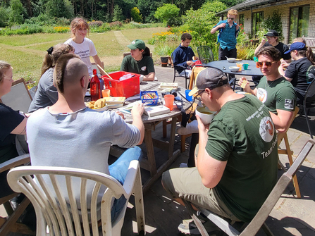Young volunteers having a meal together