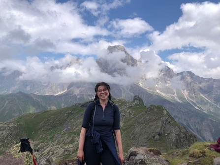 Rhoda in front of cloudy mountain vista