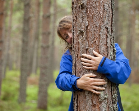 Woman hugging a tree