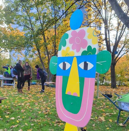 a wooden mulitcoloured sculpture of a face