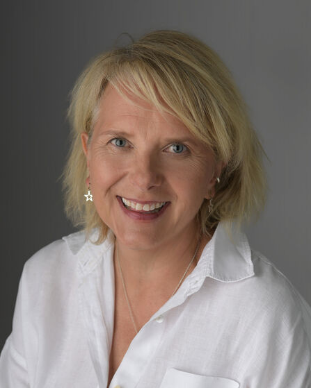 A photo of a ladies head wearing a white shirt
