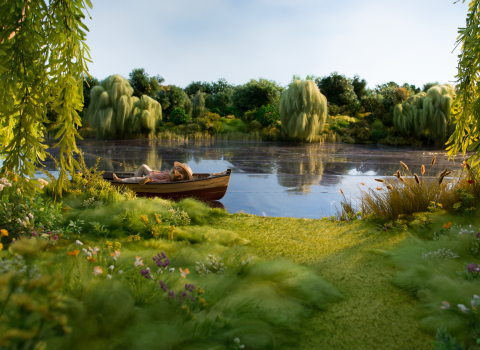 Ratty from The Wind in the Willows lying in a boat an a lake